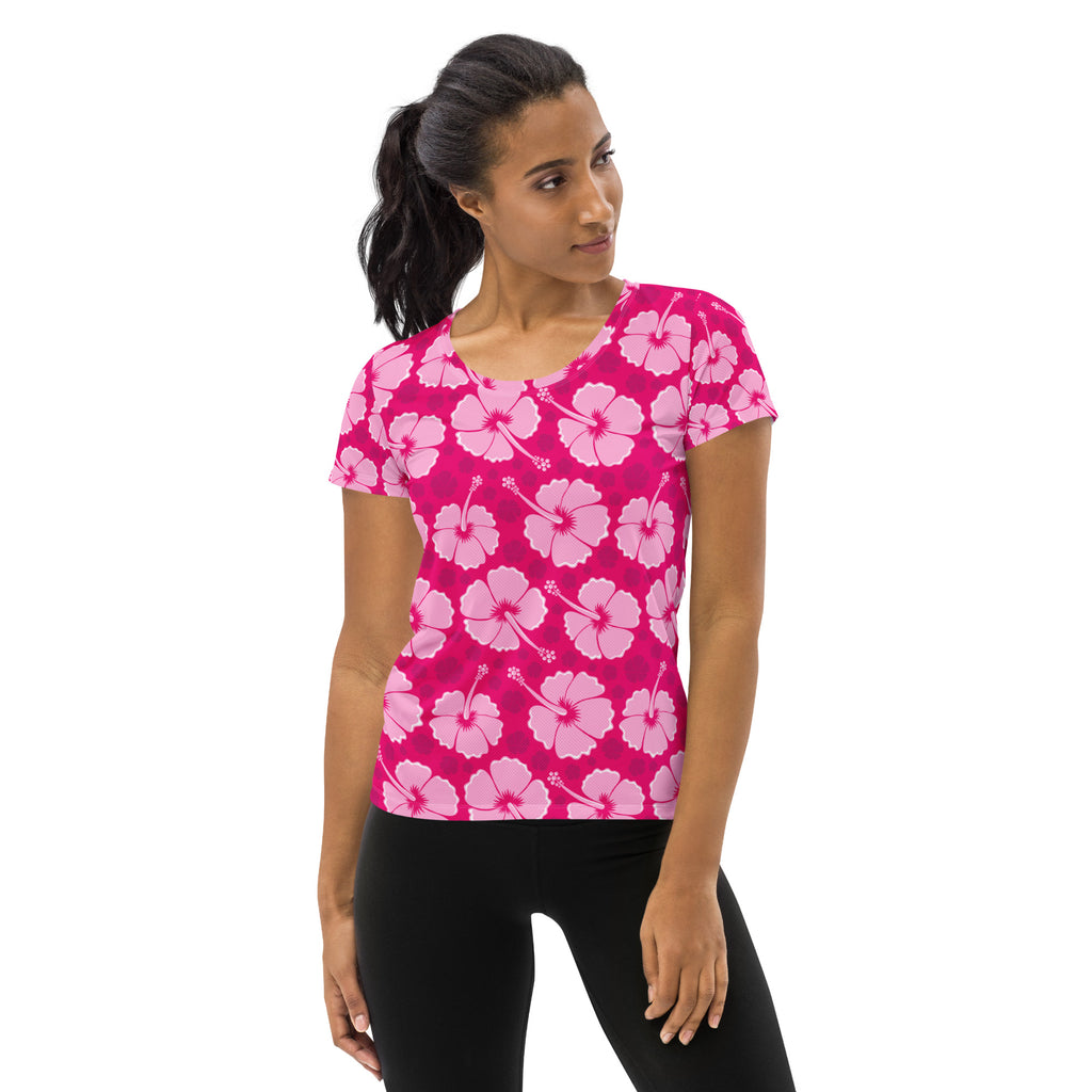 A vibrant pink women’s hibiscus performance athletic t-shirt with light pink flowers, moisture wicking and UPF 50 plus