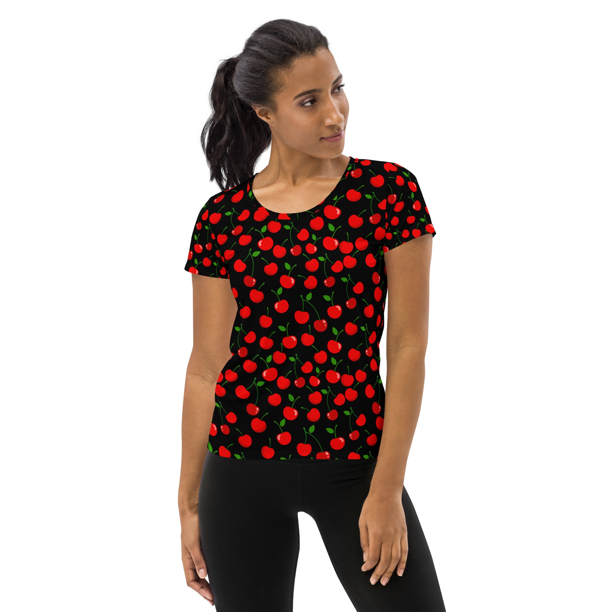 Black short-sleeved women’s performance t-shirt with vibrant red cherry pattern and green stems, lightweight moisture wicking with UPF 50+