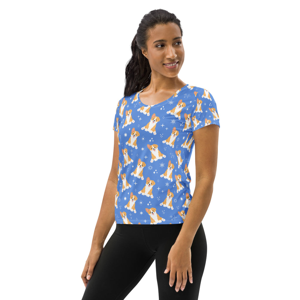 Women’s blue corgi dog performance athletic t-shirt with playful tan and white puppy pattern and lightweight moisture wicking fabric