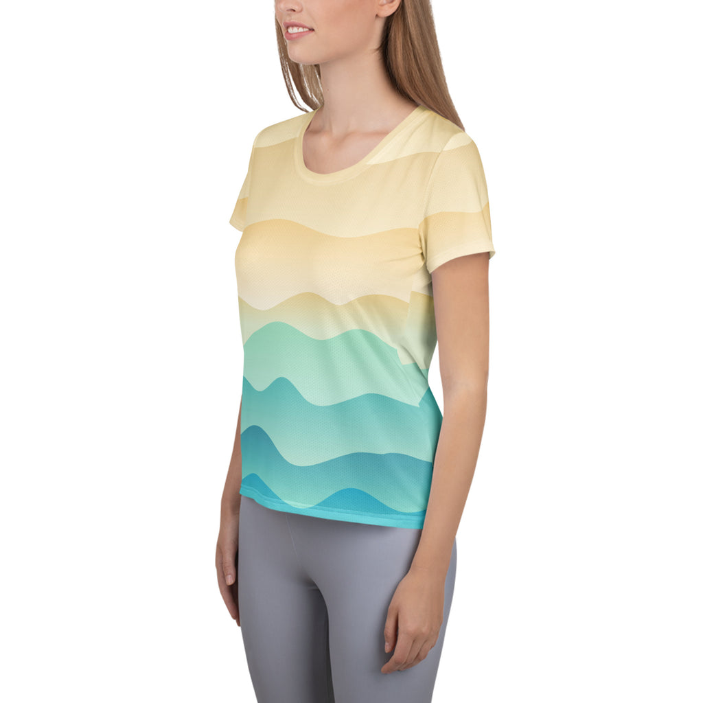 Women’s short-sleeved sand and ocean wave performance t-shirt with yellow to teal gradient wavy stripes and UPF 50+