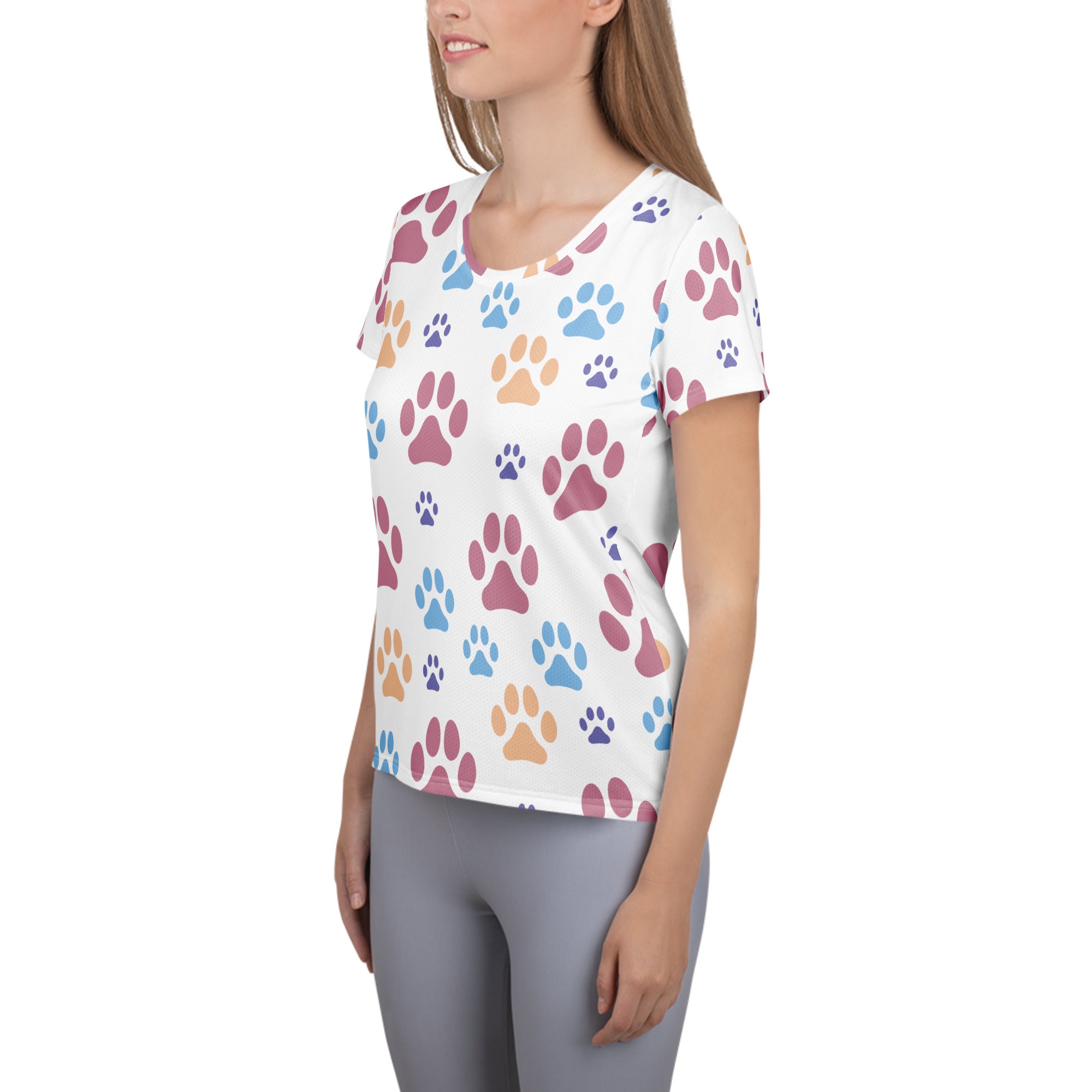 White women’s short-sleeved athletic t-shirt with colorful paw prints in pink blue and orange lightweight moisture wicking