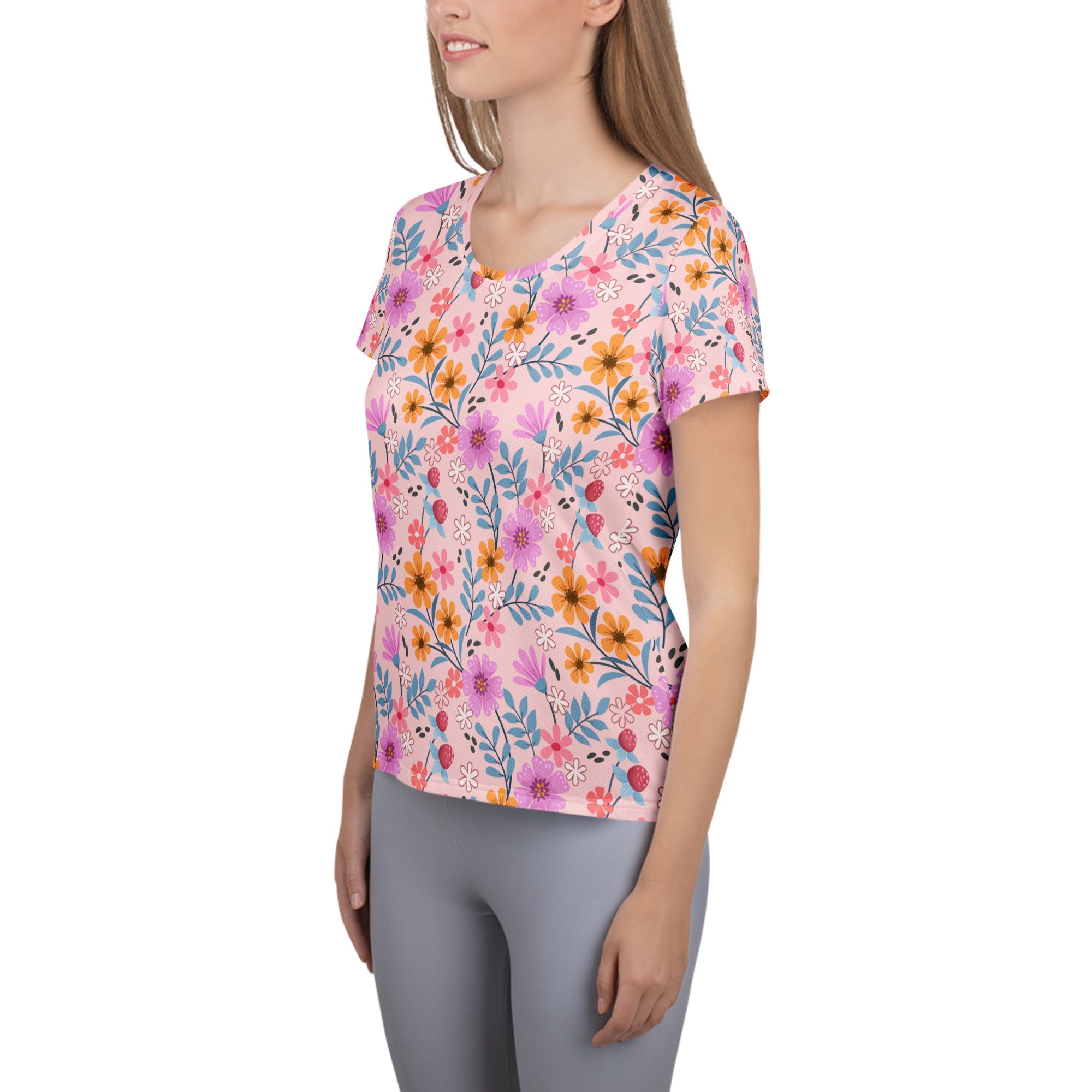 Women’s pink short-sleeved floral performance athletic t-shirt with moisture wicking fabric and UPF 50 plus protection
