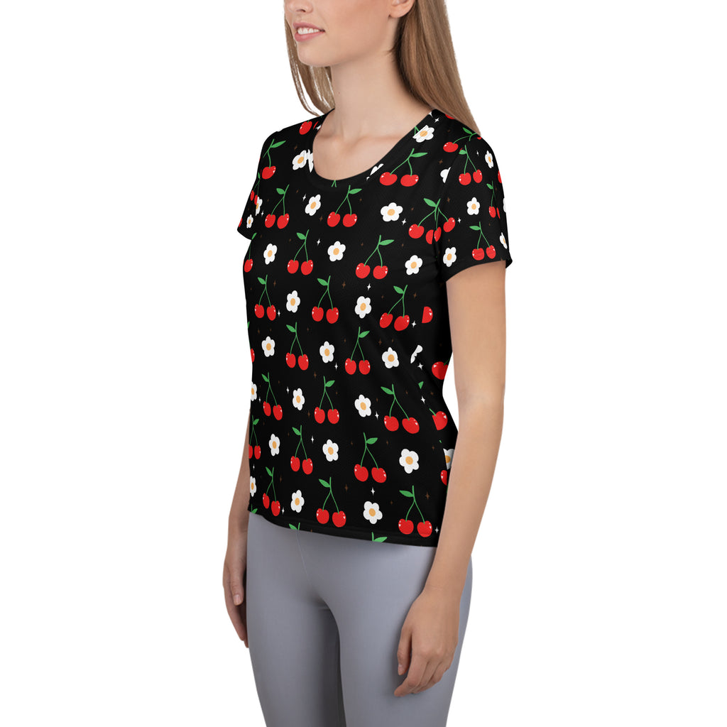 Black short-sleeved women’s cherry and daisy performance athletic t-shirt with red cherries and white flowers pattern