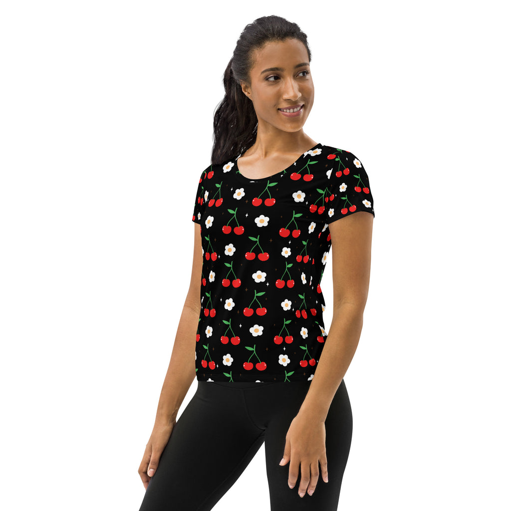 Black women’s short-sleeved performance athletic t-shirt with red cherries white daisies green stems lightweight moisture wicking