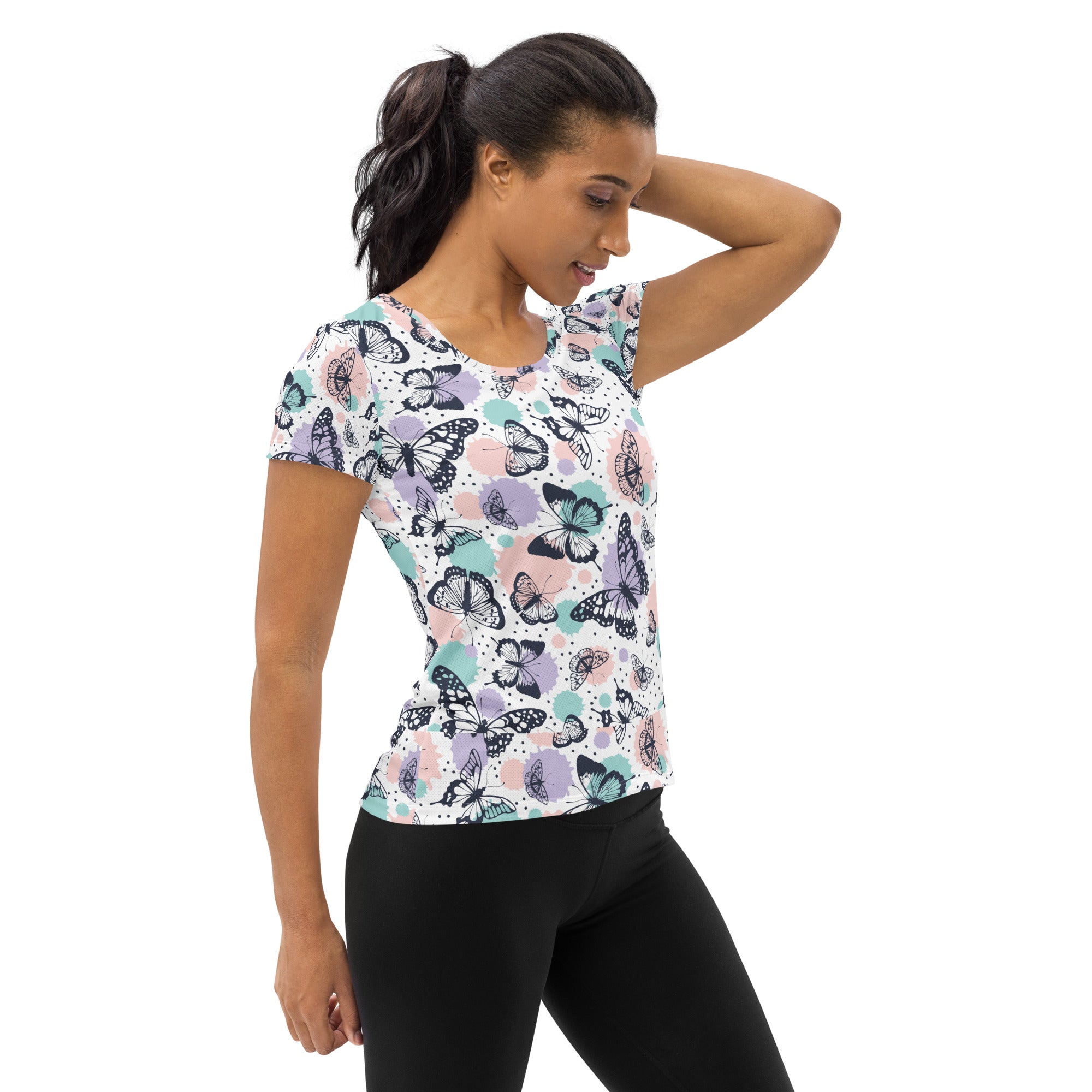 Women’s butterfly print performance athletic t-shirt with vibrant black purple pink teal pattern on white background