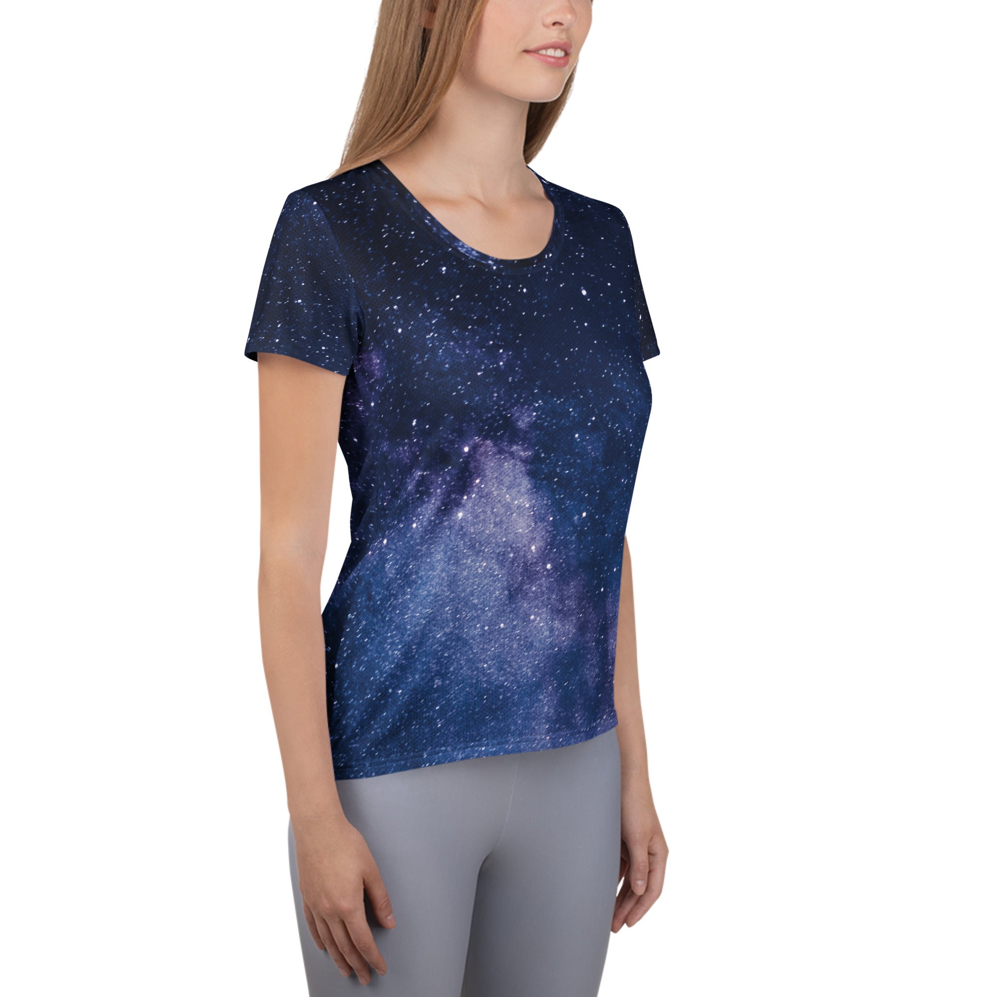 A navy blue women’s short-sleeved galaxy performance t-shirt with purple and white stars, lightweight and moisture wicking