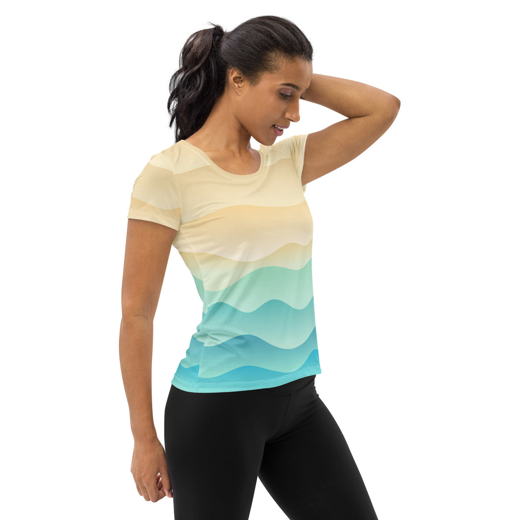 Women’s short-sleeved lightweight moisture wicking t-shirt with gradient ocean wave design in beige teal and blue