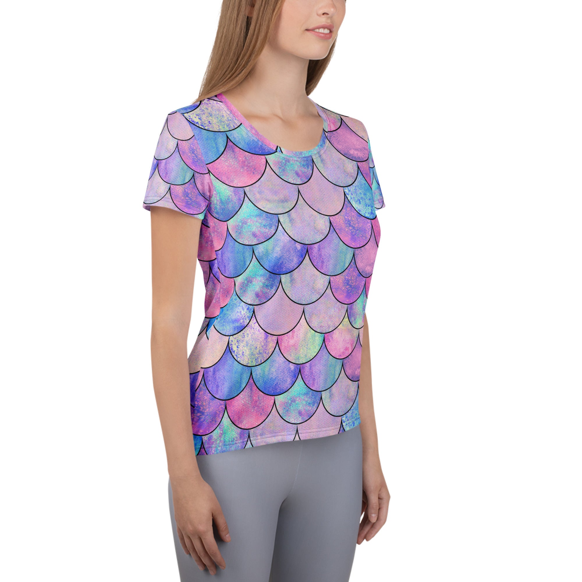 Women’s pastel mermaid performance athletic t-shirt with vibrant pink purple blue iridescent scale pattern and moisture wicking fabric