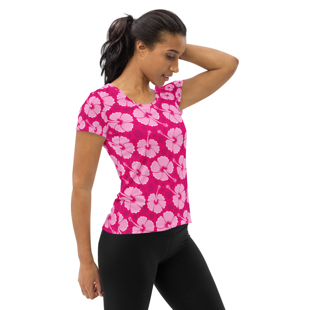 A vibrant pink women’s hibiscus performance athletic t-shirt with light pink flowers lightweight moisture wicking