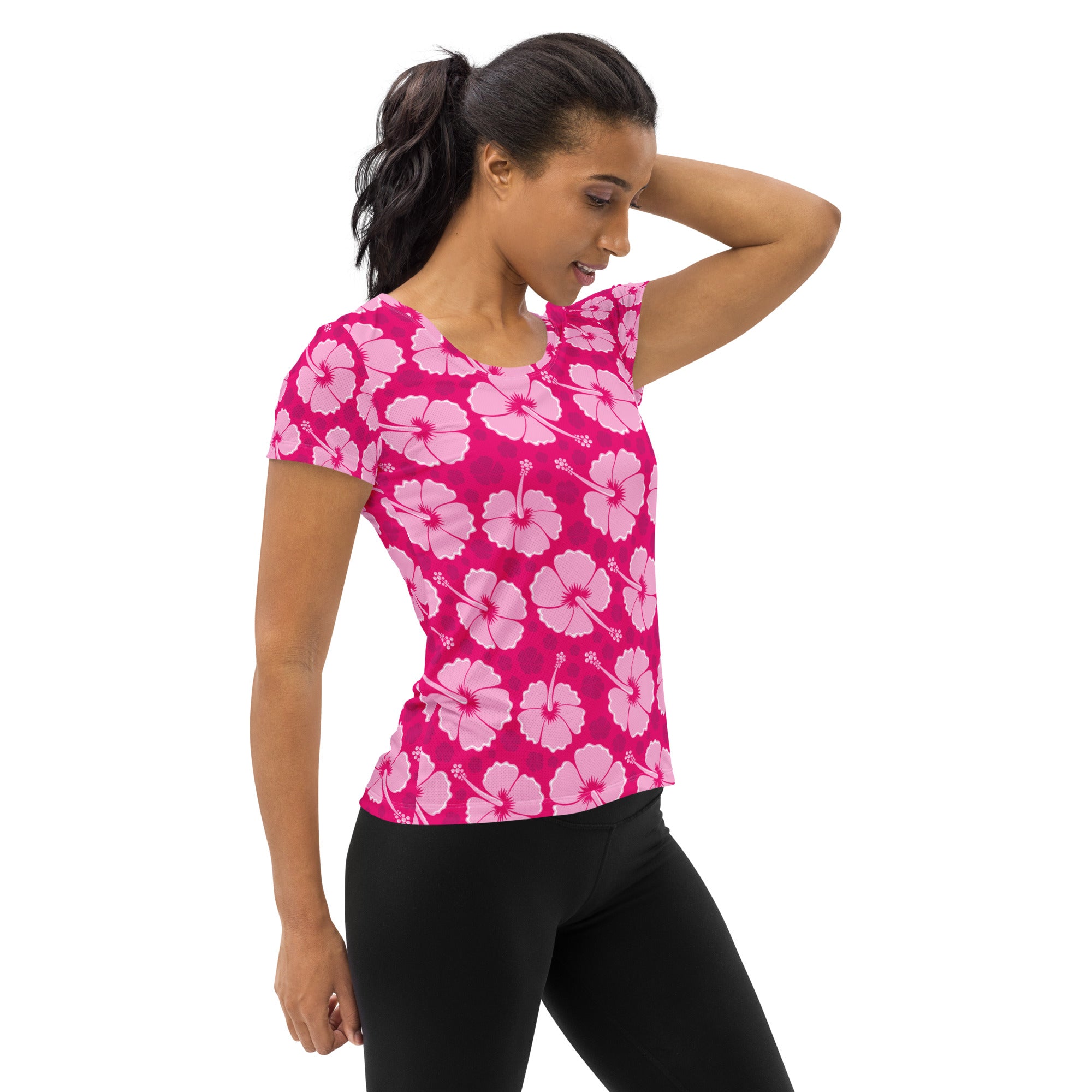 A vibrant pink women’s hibiscus performance athletic t-shirt with light pink flowers lightweight moisture wicking