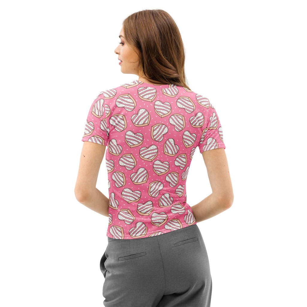 Women’s pink cotton t-shirt with soft stretch featuring a playful heart-shaped donut pattern with white icing stripes