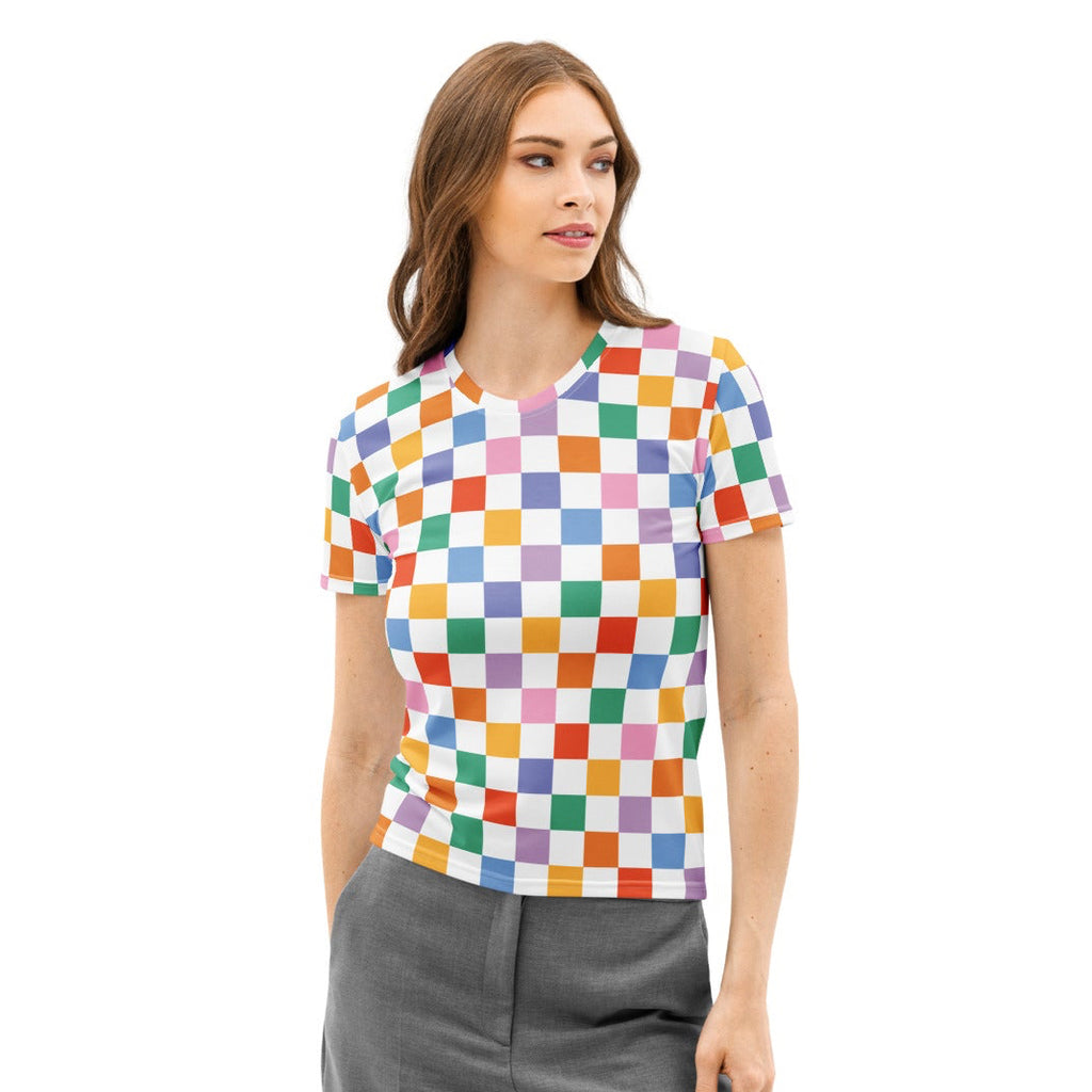 Woman wearing a colorful checkered shirt and gray pants on a white background