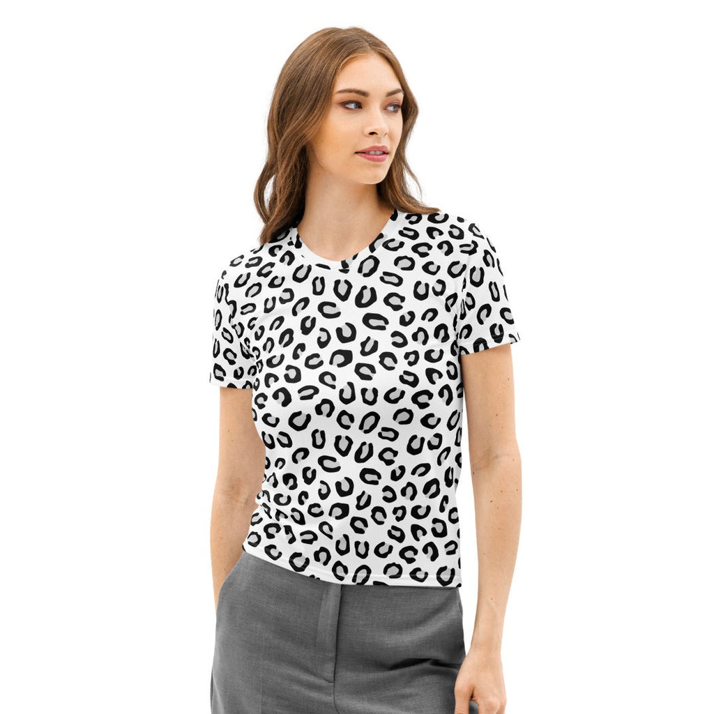 Woman wearing a black and white patterned shirt and gray pants on a white background