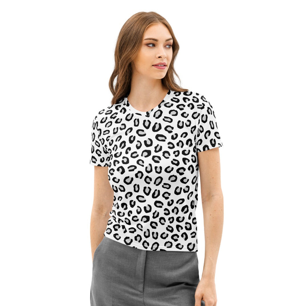 Woman wearing a black and white patterned shirt and gray pants on a white background