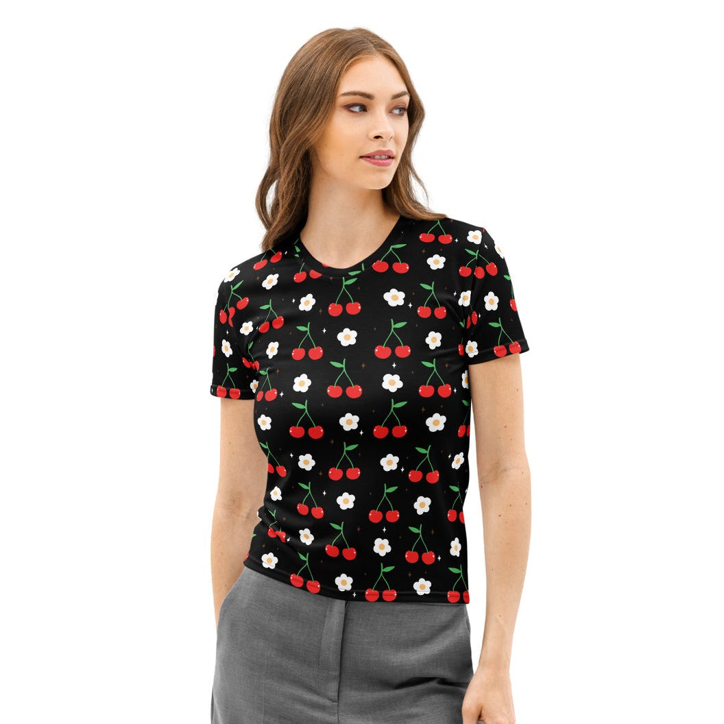 Women’s black cotton t-shirt with soft stretch featuring red cherry and white daisy print against solid background