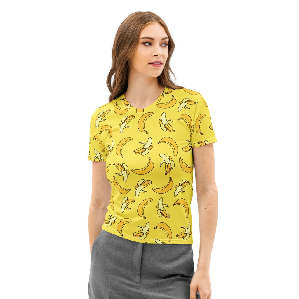 Woman wearing a yellow banana print shirt and gray pants on a white background