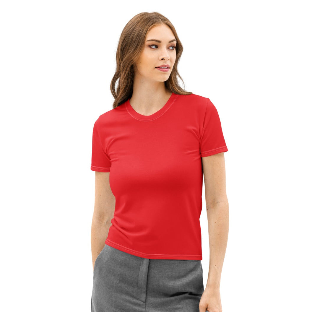 Woman wearing a red shirt and gray pants on a white background
