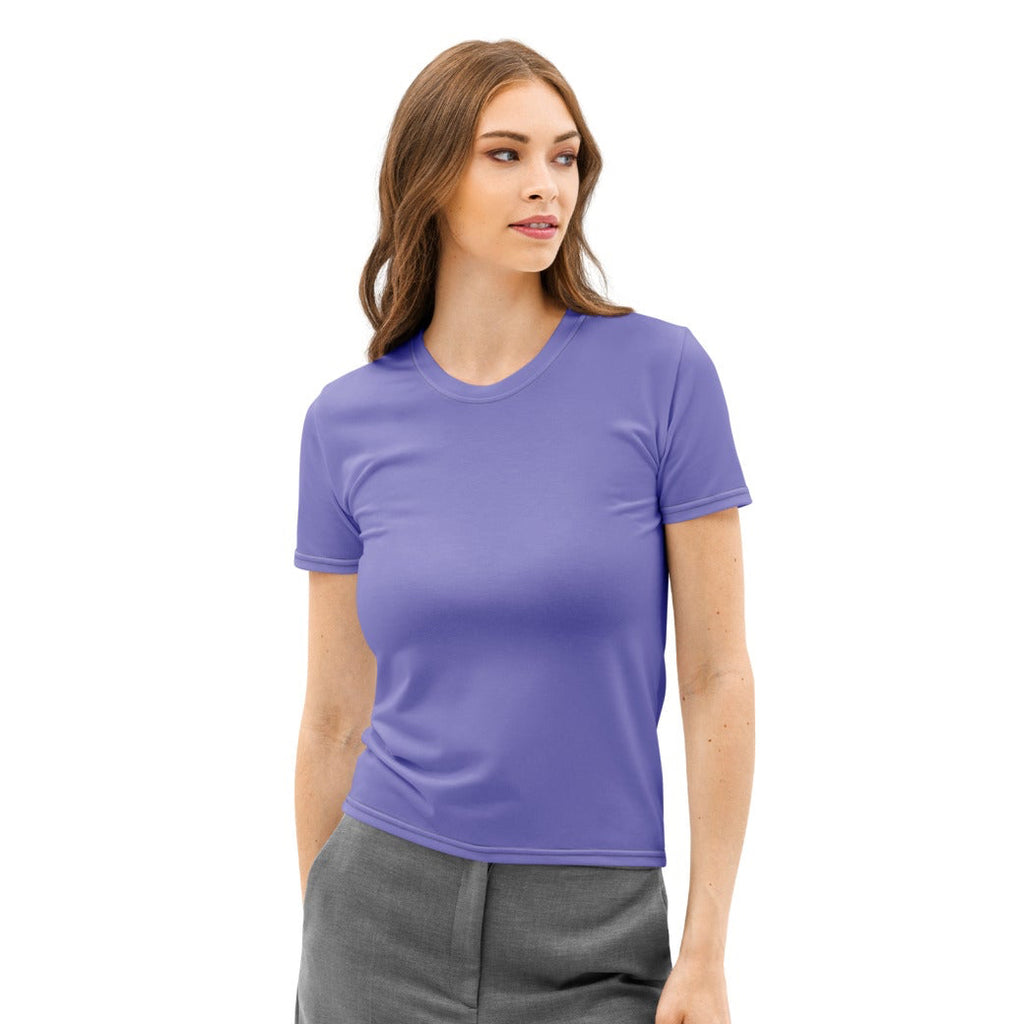 Woman wearing a purple shirt and gray pants on a white background