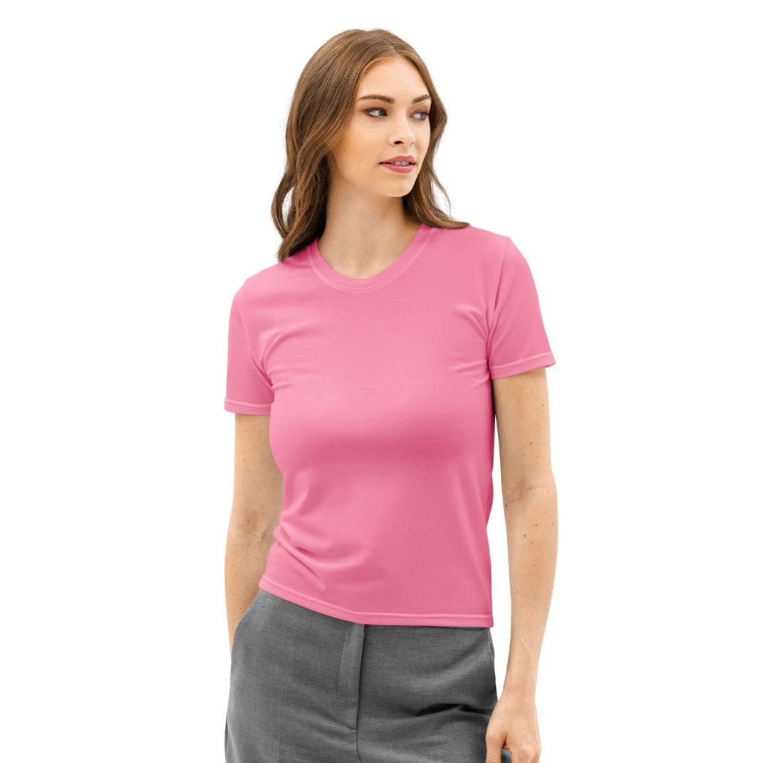 Woman wearing a pink t-shirt and gray pants on a white background
