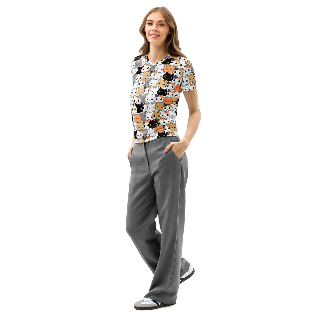 A woman wears a soft stretch women’s cat face cotton t-shirt with colorful cartoon cats on a light gray background