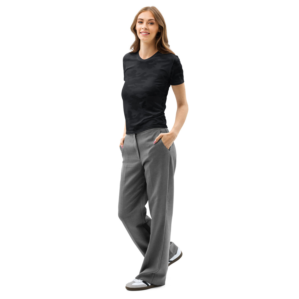 A woman wearing a women’s black camouflage cotton t-shirt with soft stretch and pilling resistant fabric paired with gray trousers