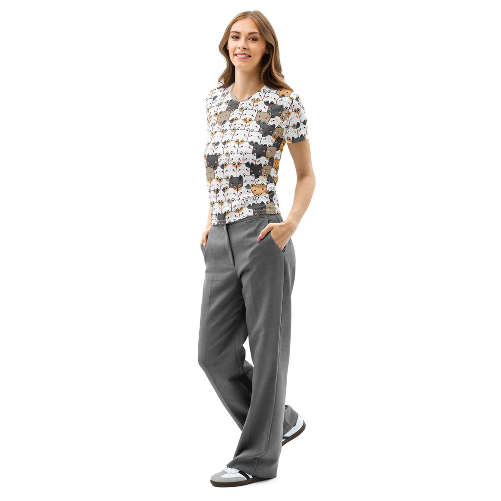 A woman wearing a women’s kawaii cat cotton t-shirt with colorful cartoon cats on a soft stretch light background