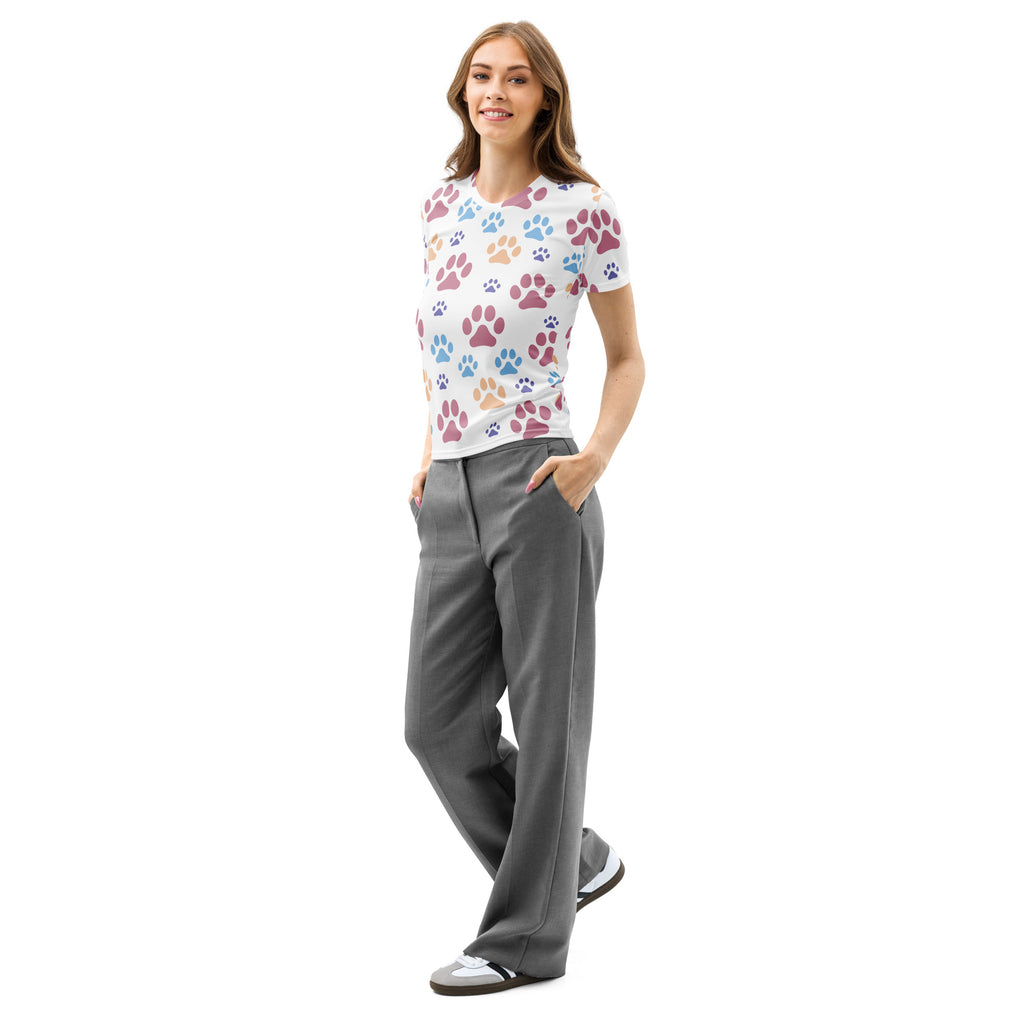 White women’s cotton t-shirt with soft stretch featuring a playful multicolored paw print pattern in pink blue and orange