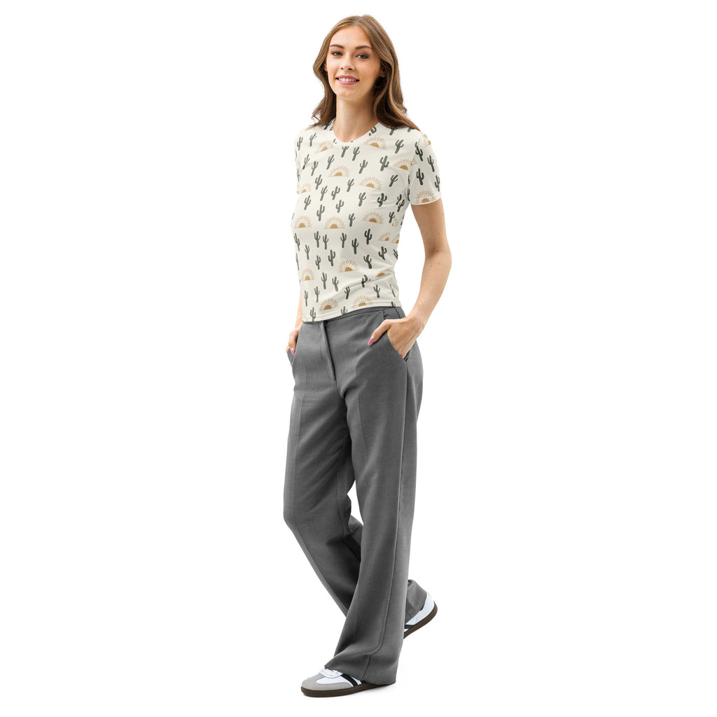 A woman wears a soft stretch off-white cotton cactus desert t-shirt with short sleeves paired with gray wide-leg trousers