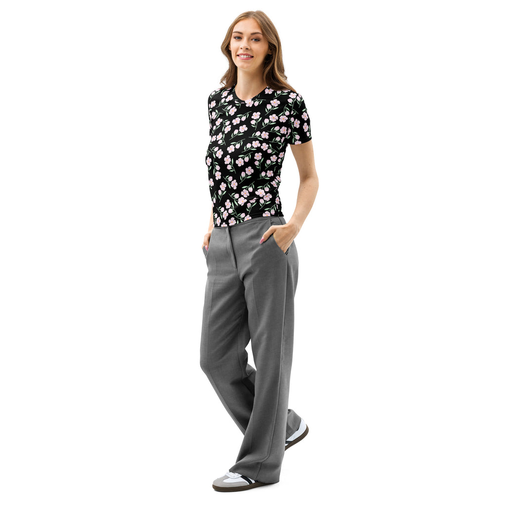 A woman wearing a women’s black floral cotton t-shirt with soft stretch and pilling resistant fabric, paired with gray trousers