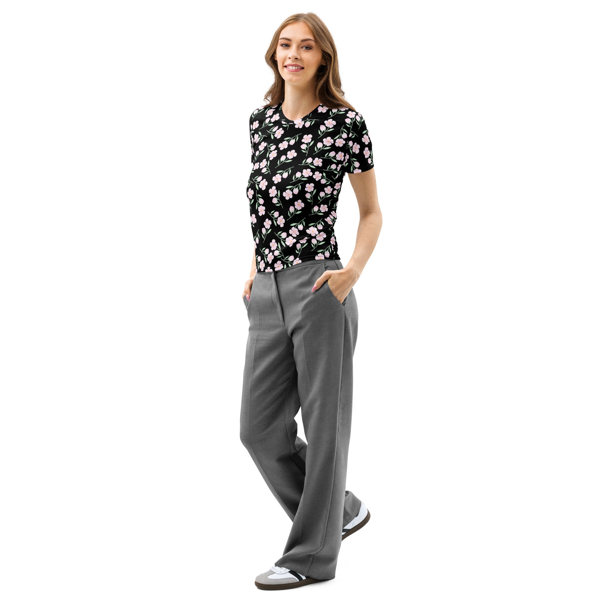 A woman wearing a women’s black floral cotton t-shirt with soft stretch and pilling resistant fabric, paired with gray trousers