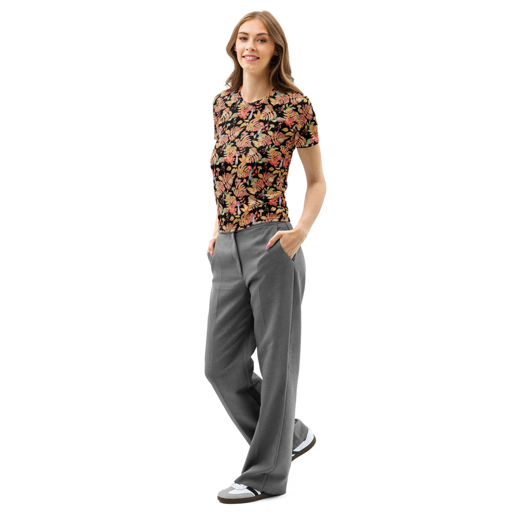 A woman wearing a women’s autumn botanical mushroom print cotton t-shirt with vibrant orange and pink floral patterns