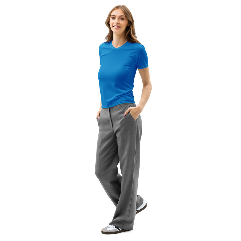 A woman wearing a vibrant blue soft stretch cotton t-shirt paired with loose-fitting gray trousers modeling the tee