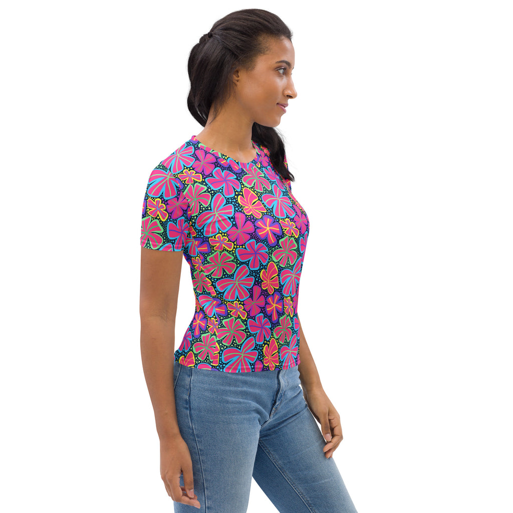 A vibrant women’s neon retro flower t-shirt with bold pink purple and yellow floral pattern on dark blue soft stretch jersey