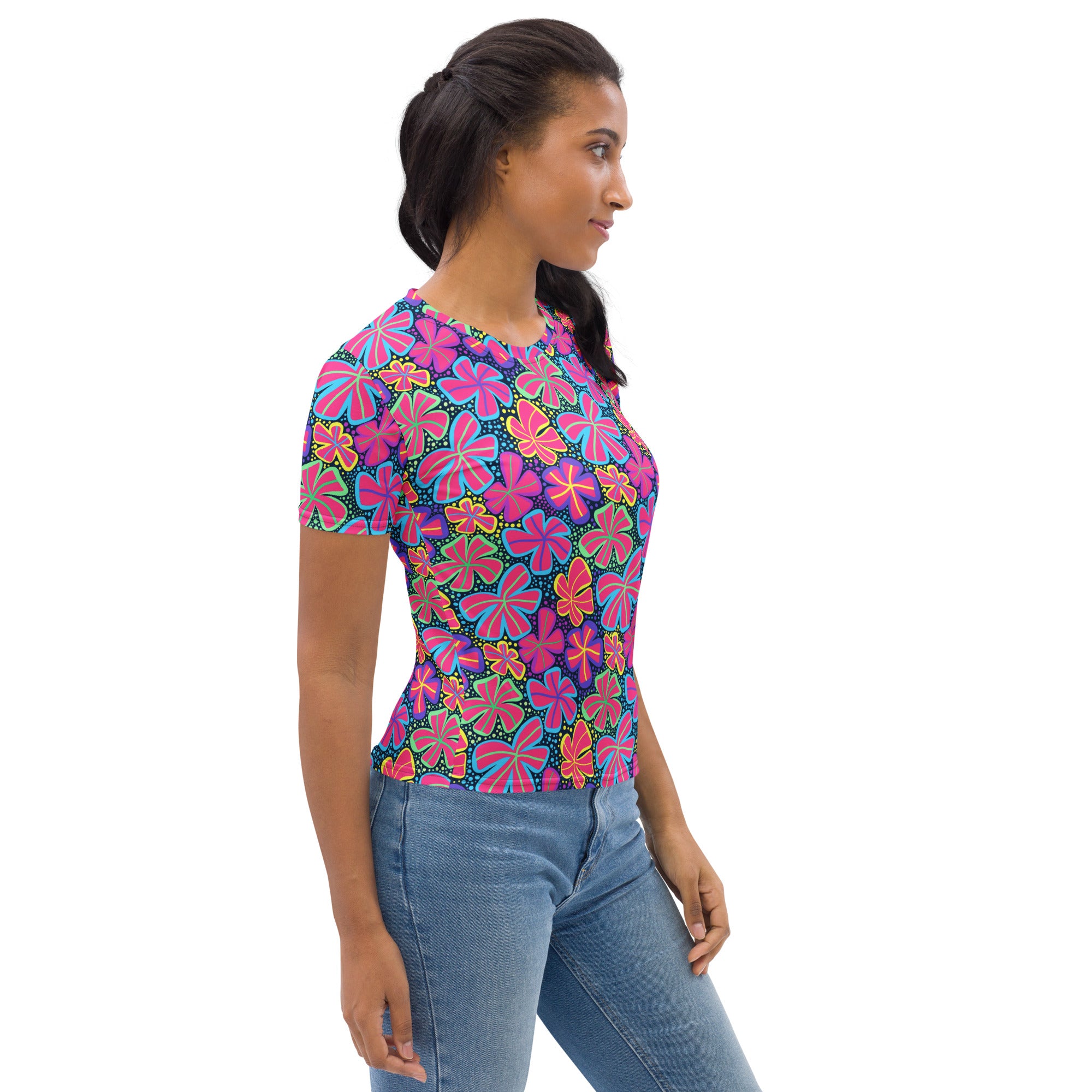 A vibrant women’s neon retro flower t-shirt with bold pink purple and yellow floral pattern on dark blue soft stretch jersey