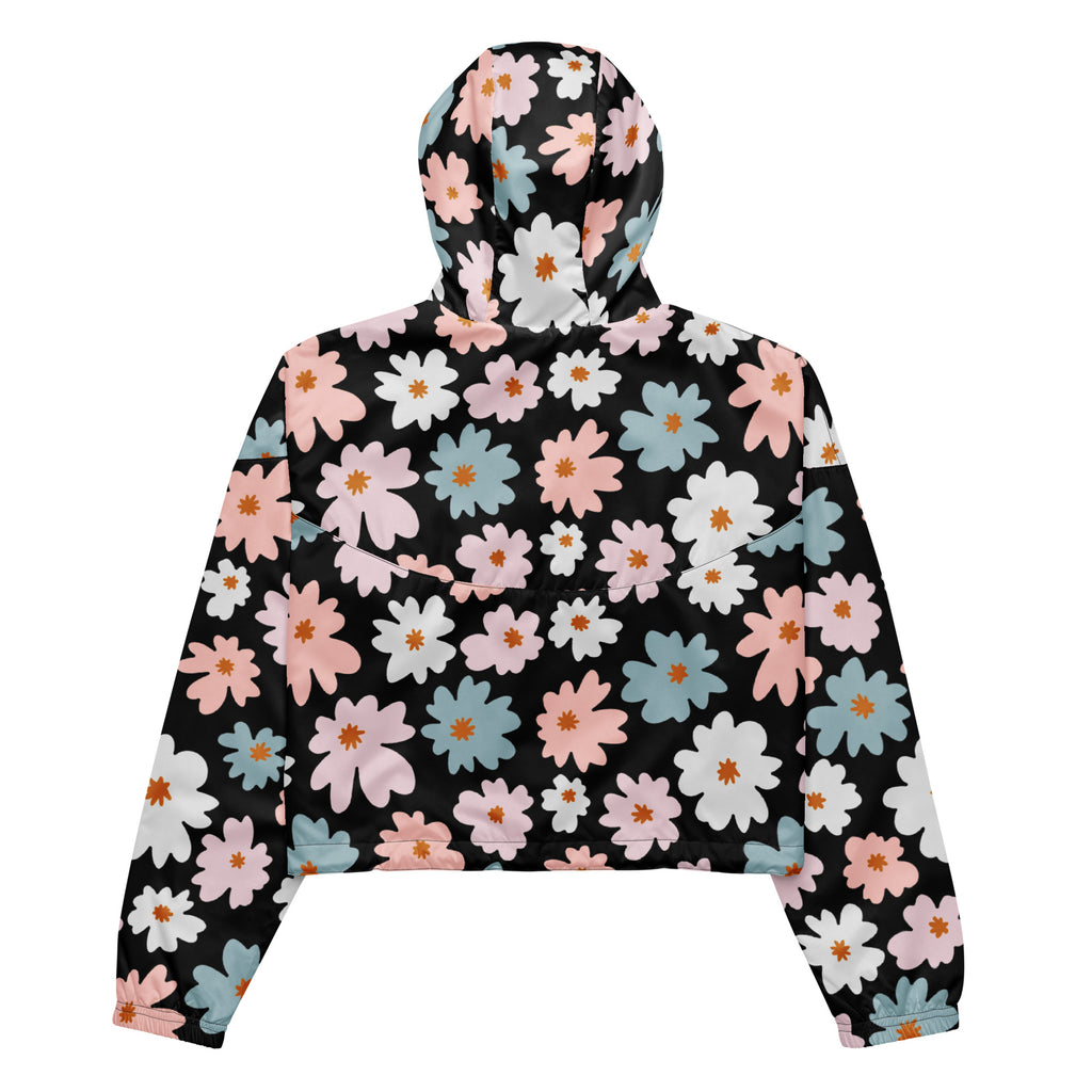 Women’s black cropped windbreaker with vibrant pink white and blue daisy pattern and adjustable hood and pockets