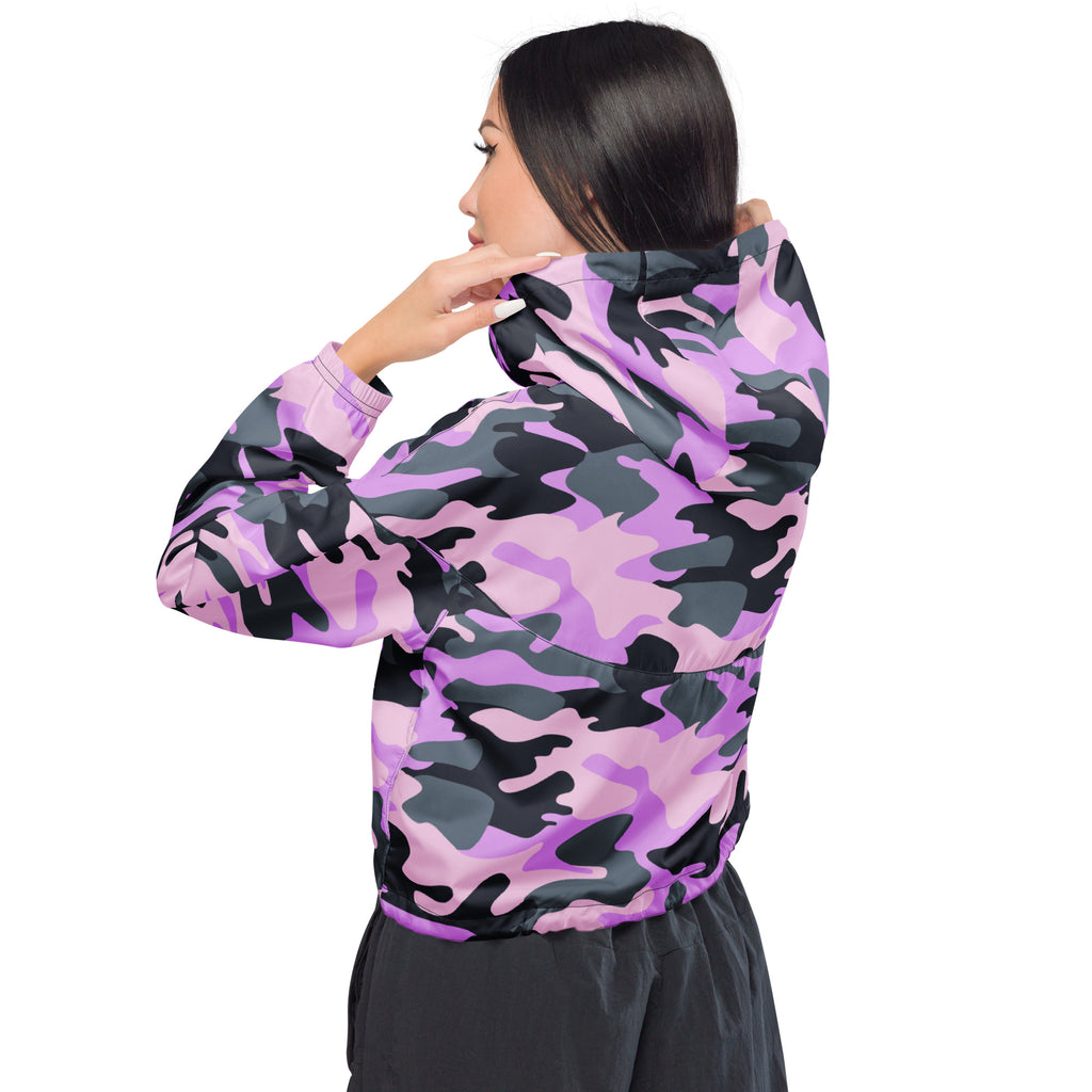 A vibrant pink and black camouflage patterned women’s cropped windbreaker with adjustable hood and pockets