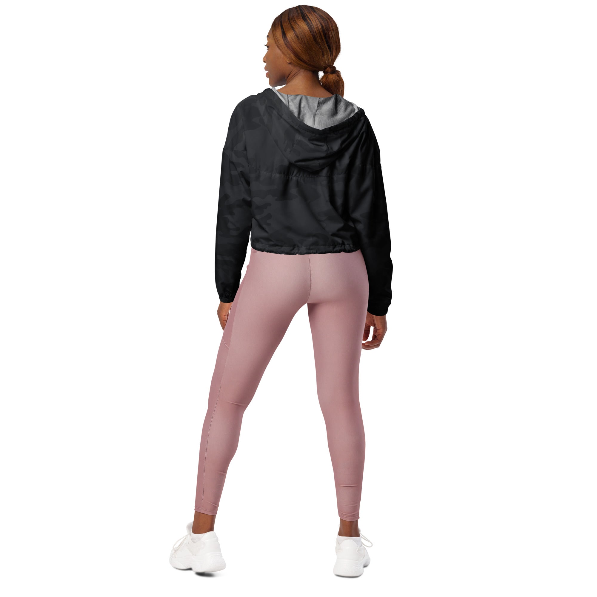 Women’s black camouflage cropped windbreaker with gray inner lining and adjustable hood shown with pink leggings