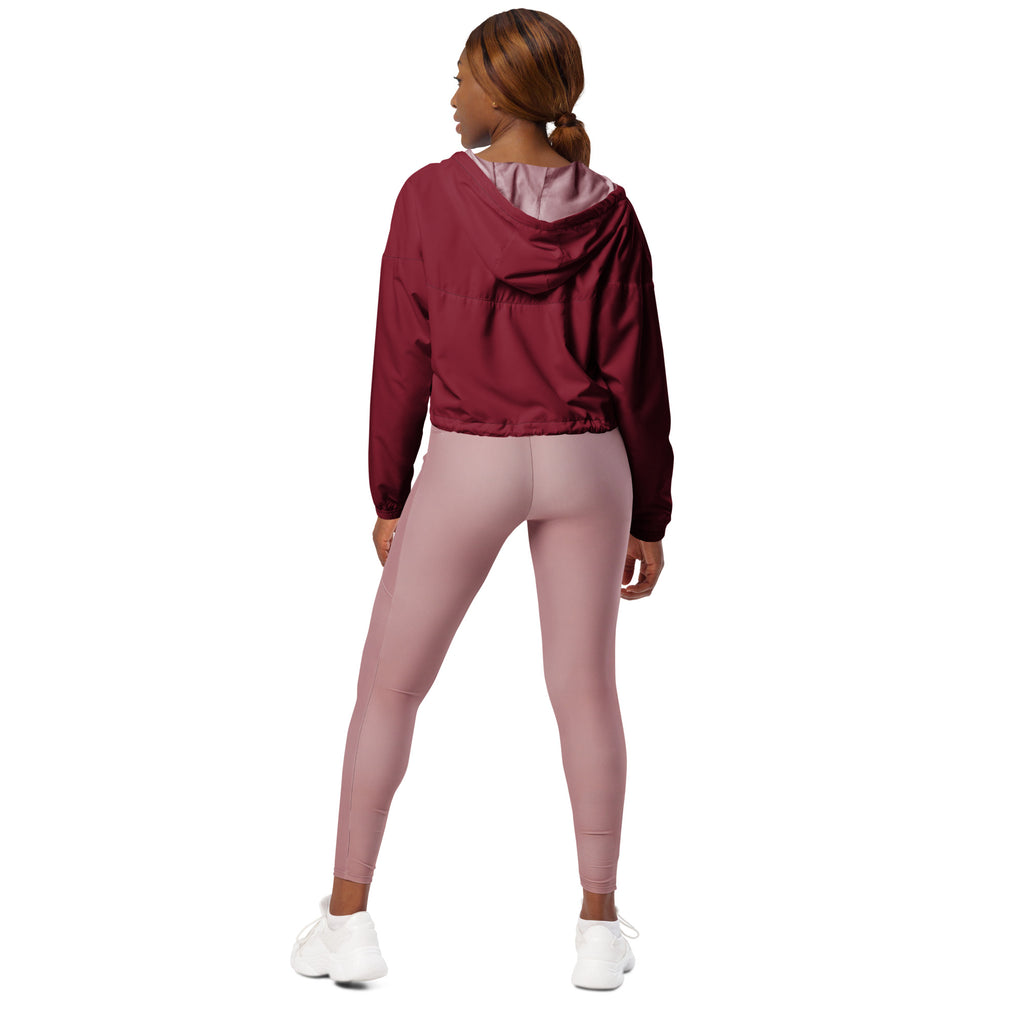Women’s burgundy cropped windbreaker with subtle sheen, lightweight water resistant fabric, adjustable hood, and pink lining