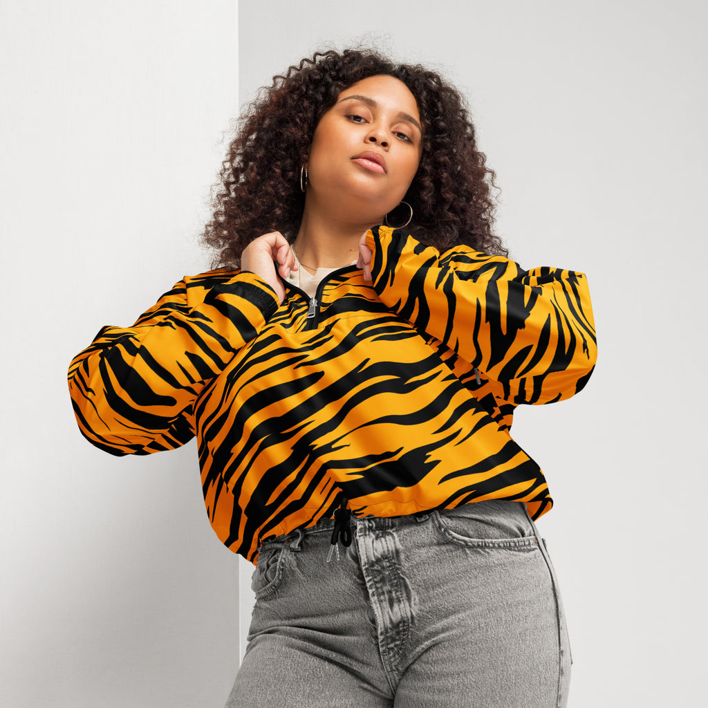 A vibrant orange and black tiger-striped women’s cropped bomber jacket with half-zip front and adjustable hood