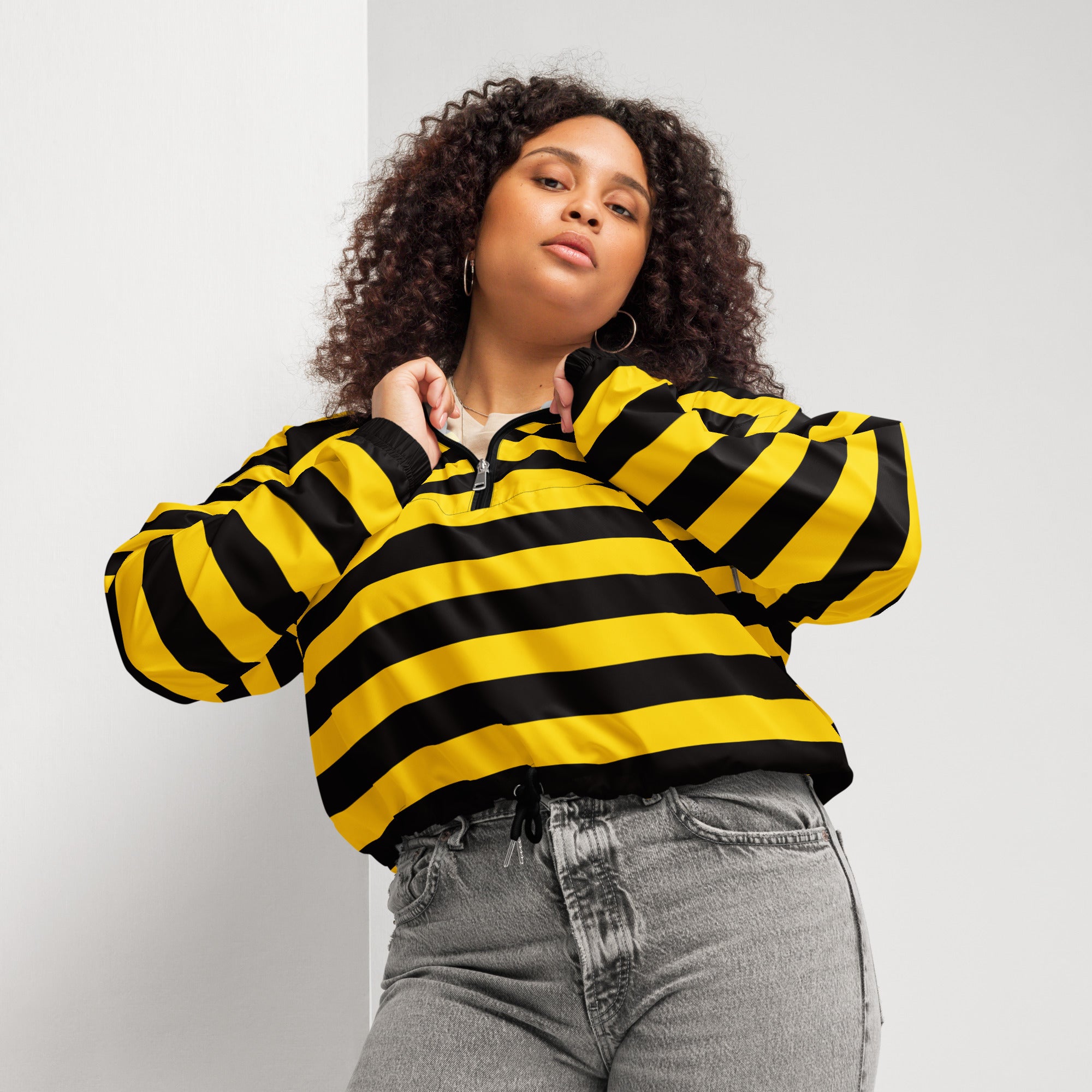 Yellow and black striped womens cropped bomber jacket with half zip front and adjustable hood for lightweight protection