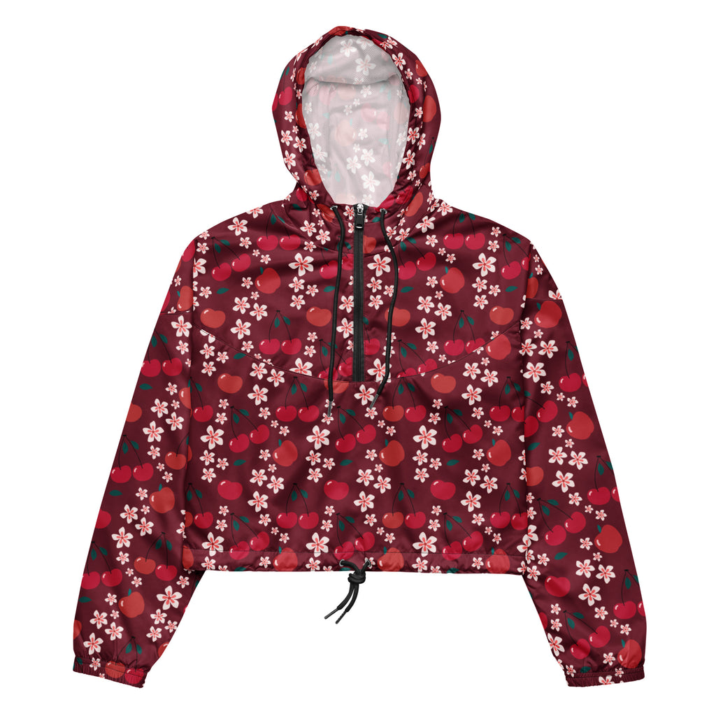 A maroon women’s cropped windbreaker with black zipper and drawstring featuring red apples and pink cherry blossoms pattern