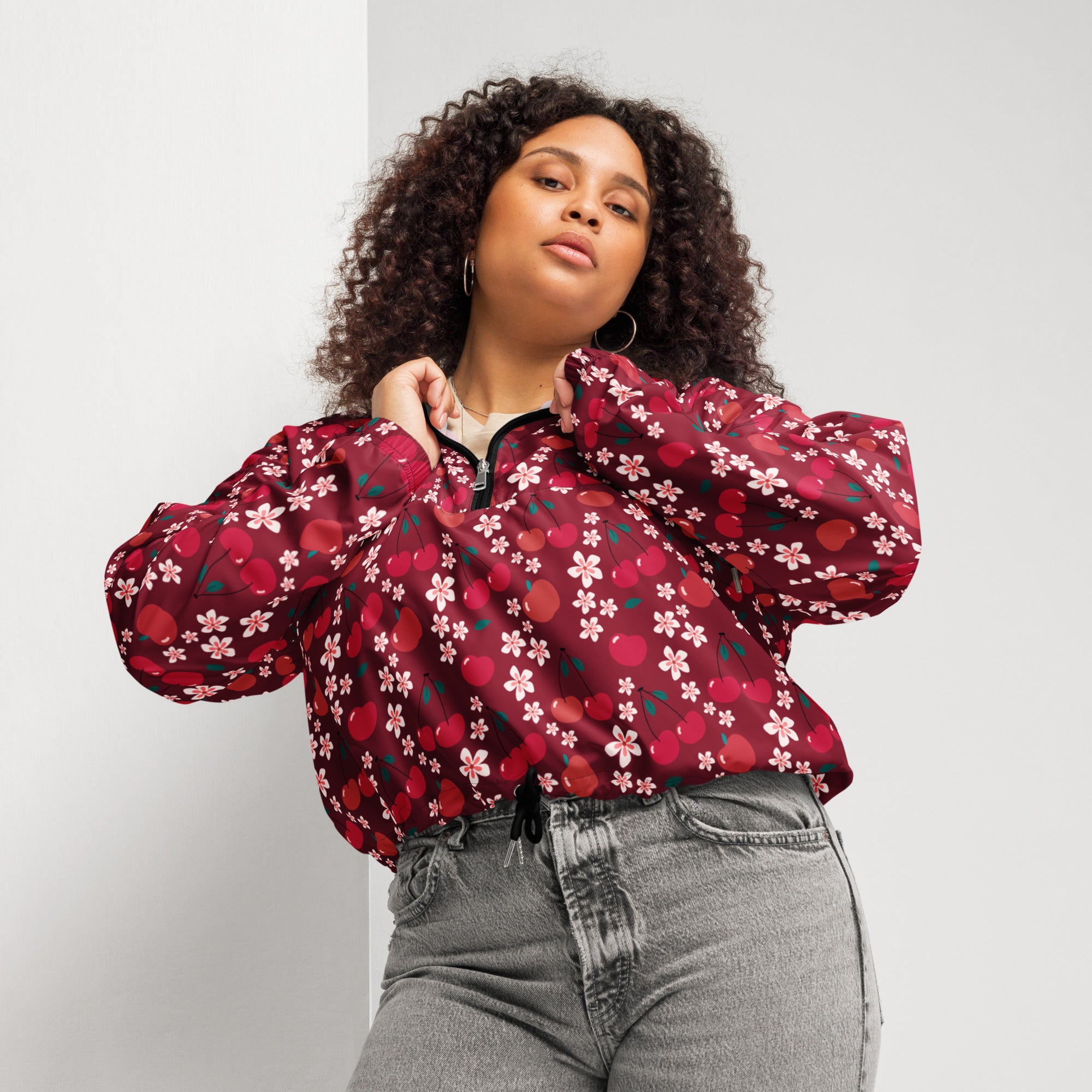 Women’s vibrant red cherry blossom cropped bomber jacket with puffy sleeves and black zipper closure