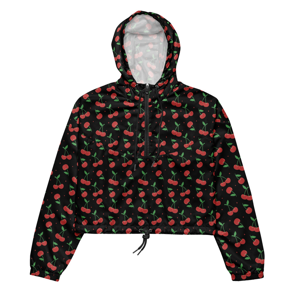 Women’s black cherry cropped windbreaker with red cherry print, drawstring hood, front zipper, and pockets on black fabric