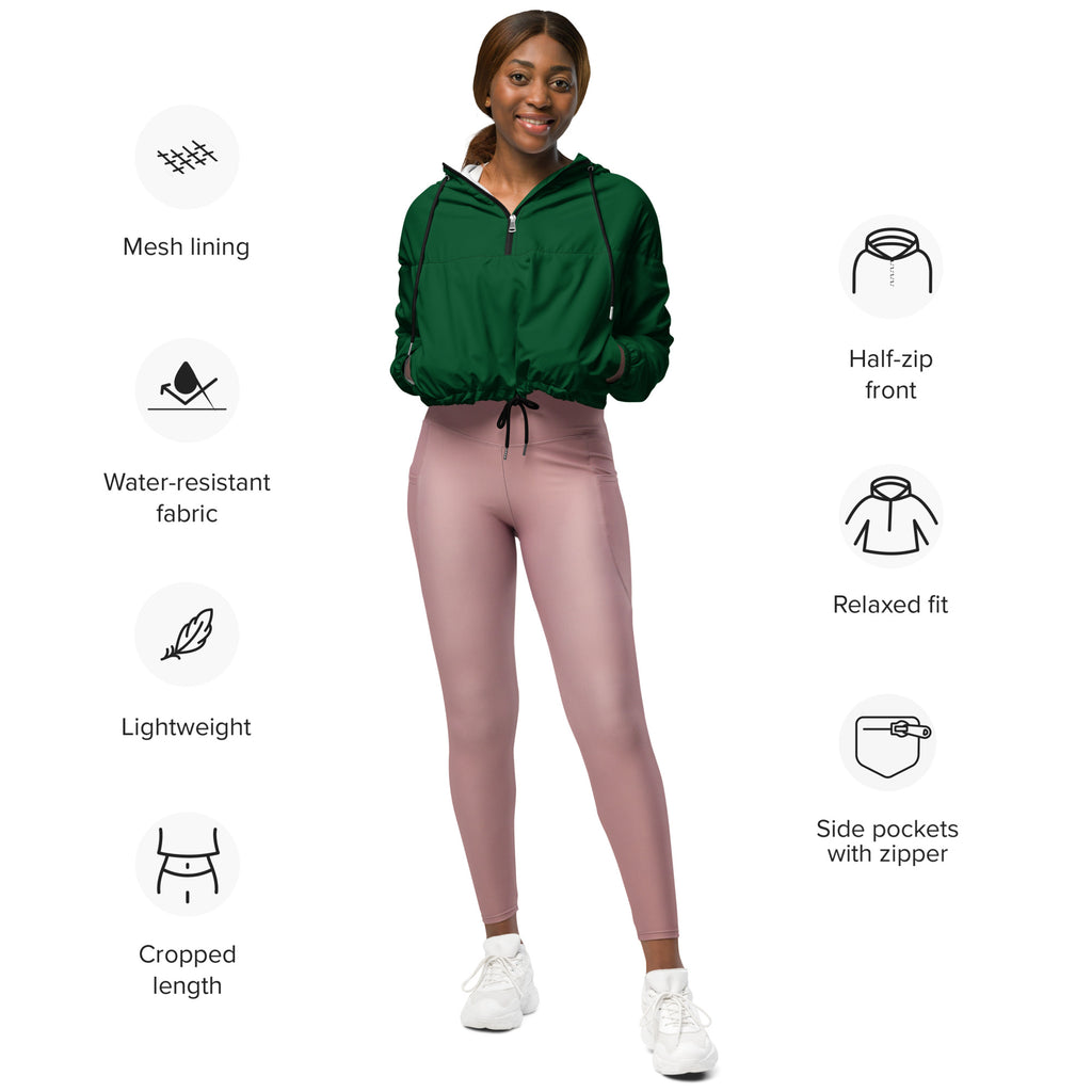 A woman wears a dark green cropped lightweight water resistant windbreaker jacket with mesh lining and zippered pockets