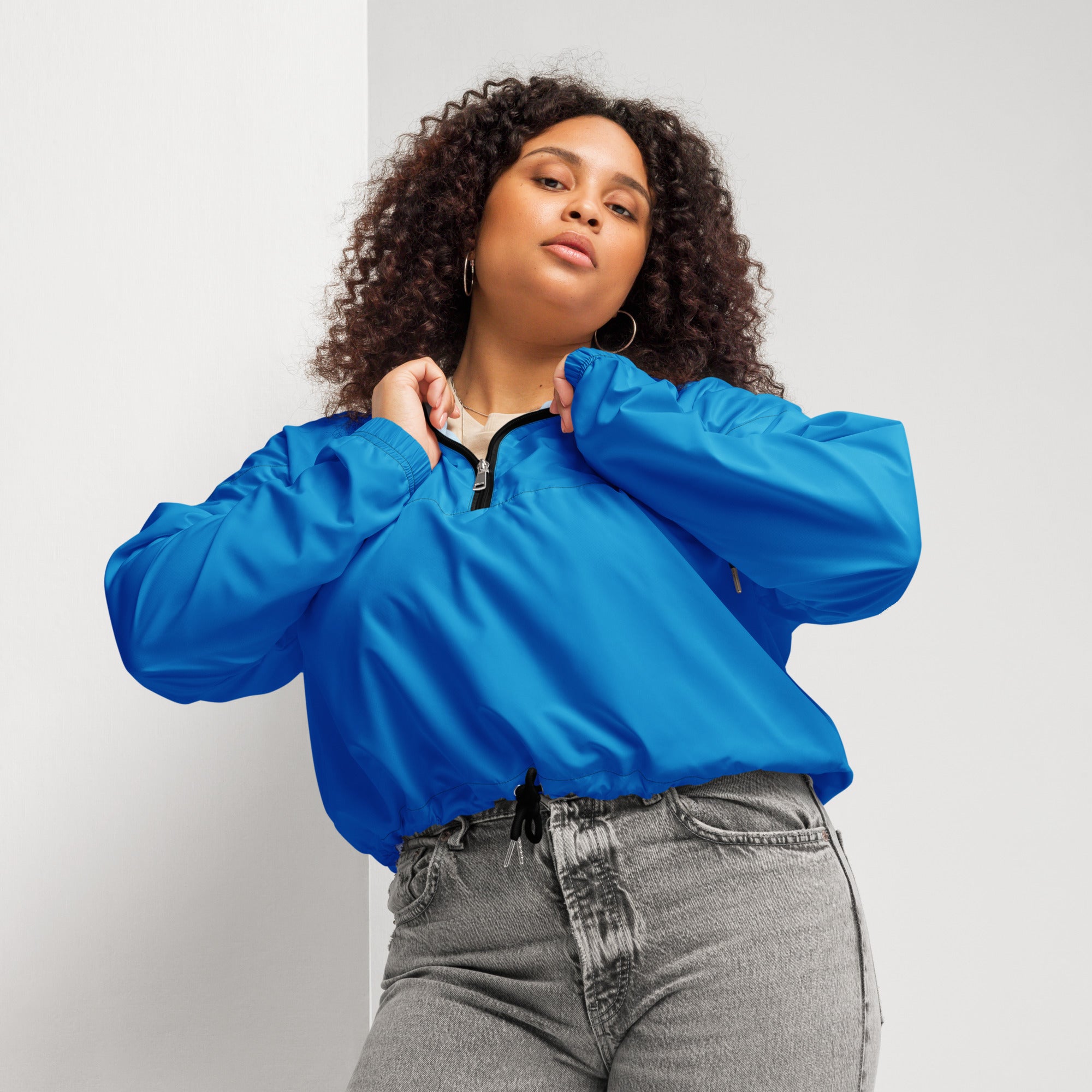 Women’s blue cropped nylon bomber jacket with black zipper and drawstring waist lightweight and water resistant