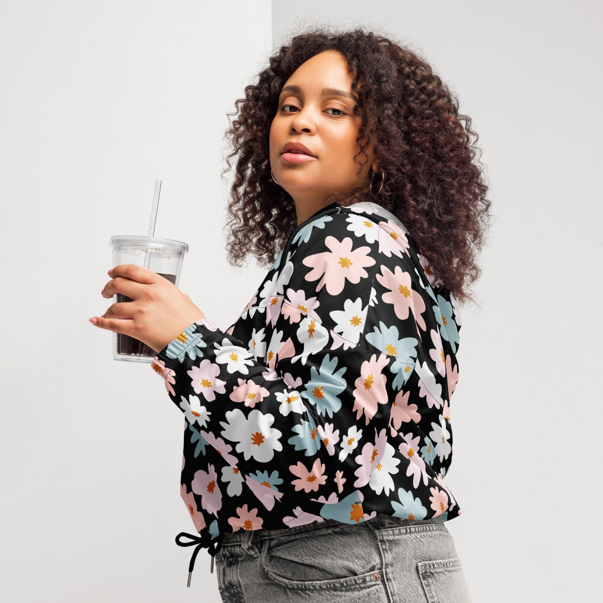 Black long-sleeved blouse with vibrant pastel pink white and blue floral pattern lightweight water resistant jacket