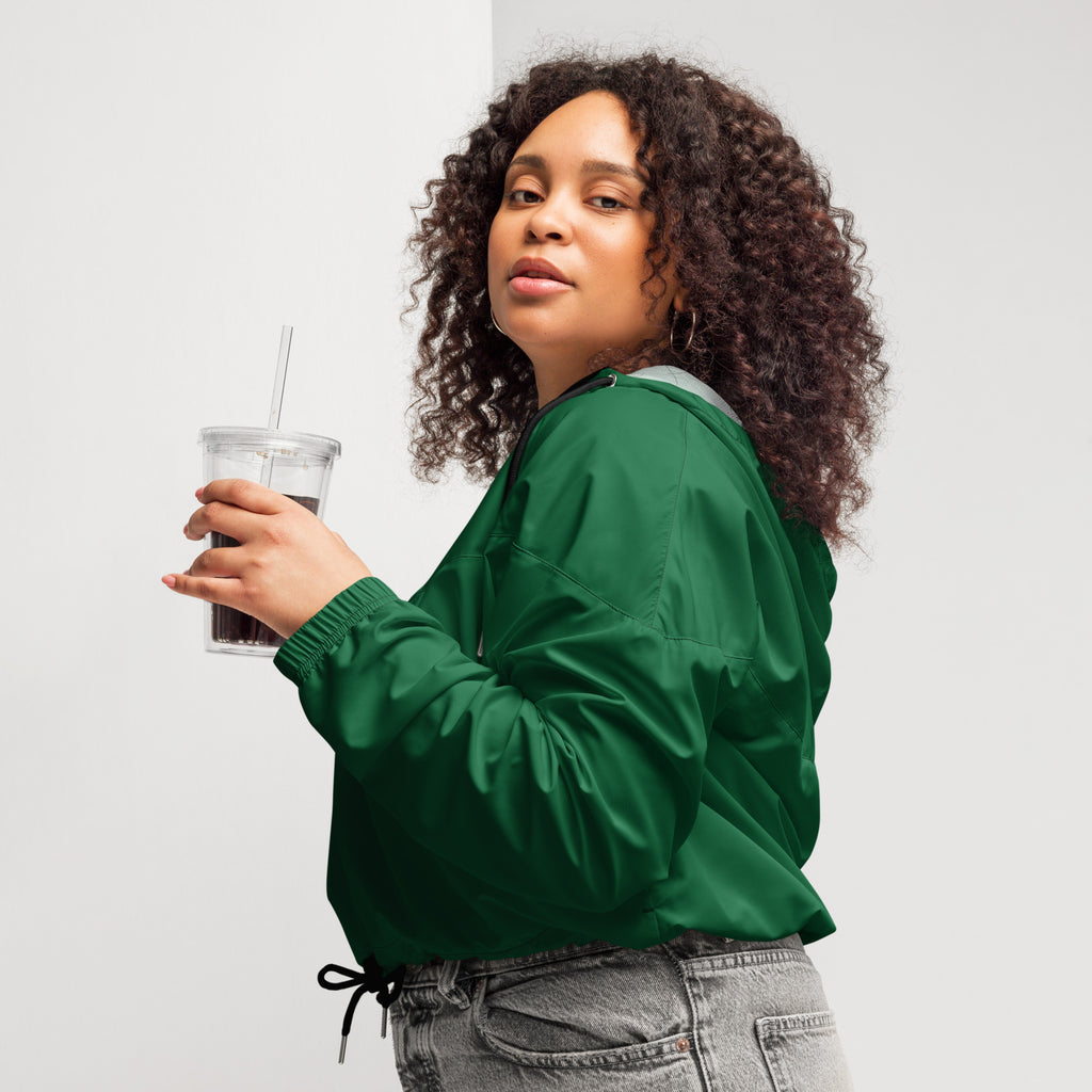 Women’s dark green cropped windbreaker with adjustable hood, drawstring waist, ribbed cuffs, and pockets, lightweight and water resistant