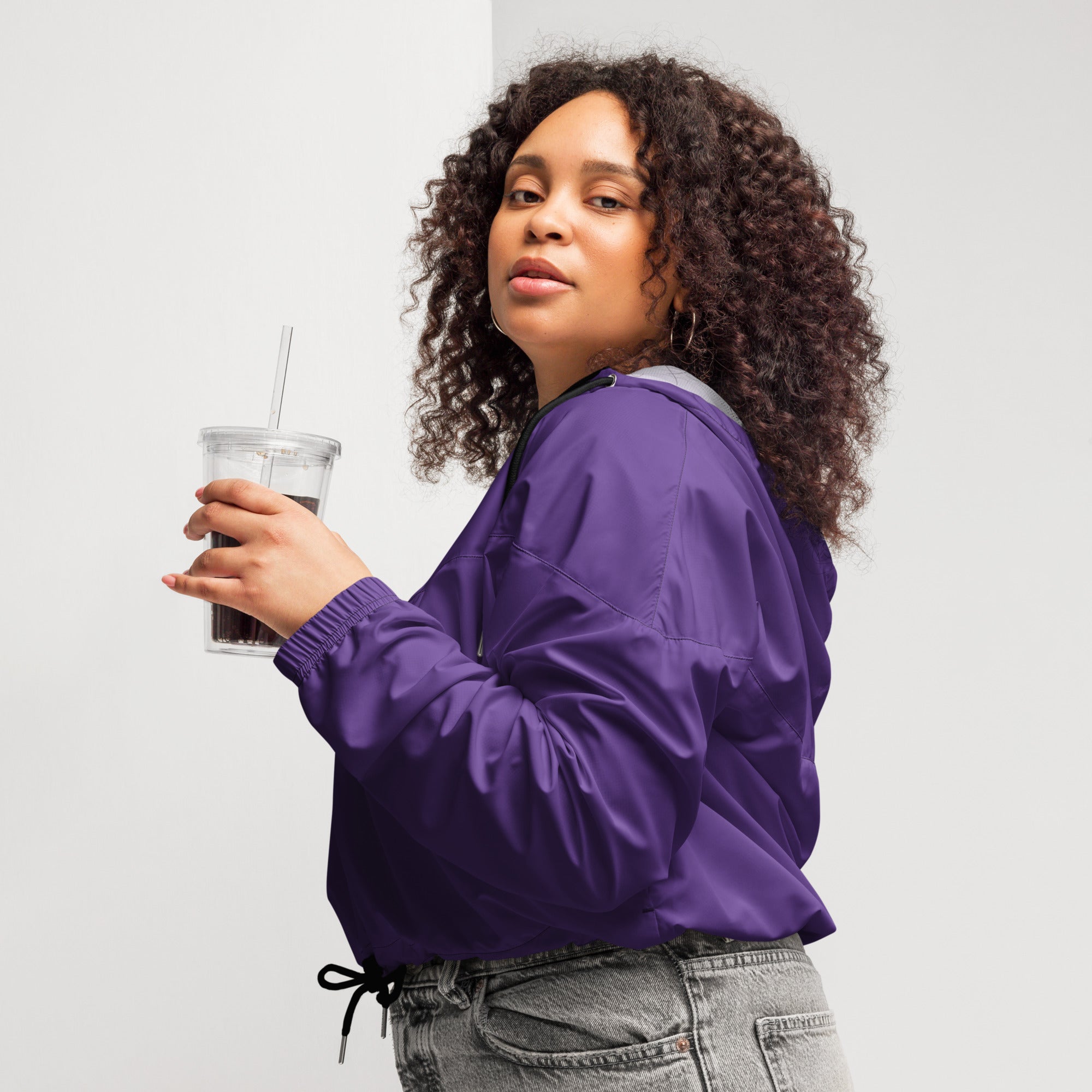 Women’s dark purple nylon bomber jacket with drawstring waist and gray inner lining, lightweight and water resistant