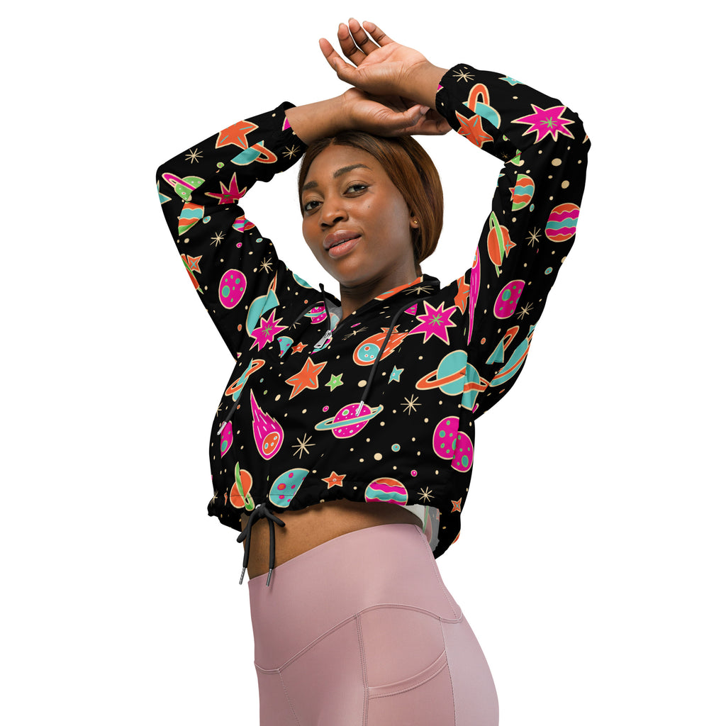 Women’s black cropped hoodie with vibrant space-themed print in pink teal orange and green featuring planets stars and rockets