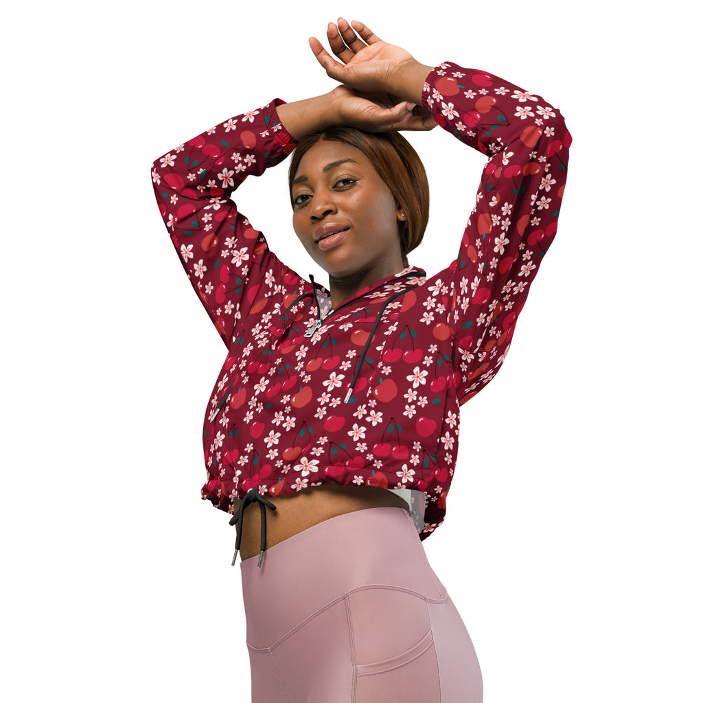A vibrant red women’s cherry blossom cropped windbreaker with black drawstrings and floral cherry pattern